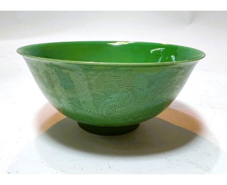 A Chinese ceramic jade coloured bowl, with incised dragon decoration to the outside, six character mark to base, diameter 15c