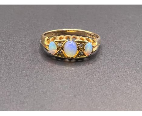 An 18ct hallmarked gold gypsy style ring set with 3 opal coloured stones and diamond chips, 3.4gm, size Q-R 