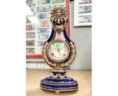 A modern 18th century style mantel clock in gilt metal and blue enamel, with sunburst pediment. height 37cm 