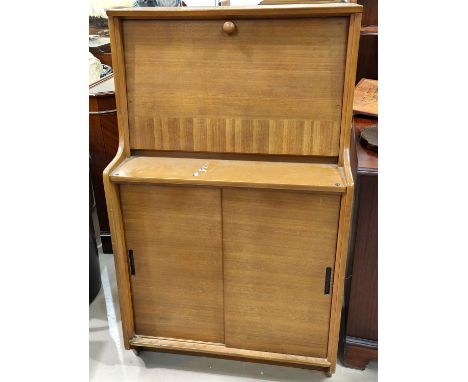 A mid 20th century teak hinge lidded bedding box and a mid 20th century light wood bureau with fall front writing surface and