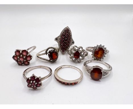 A selection of silver rings set with a variety of red coloured stones 