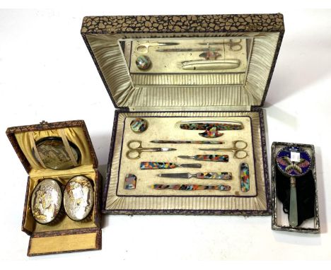 A 1930's used manicure set; a 1930's boxed dressing table set with chinoiserie decoration; a butterfly cloisonne hand mirror 