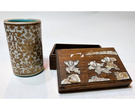 A Chinese ceramic brush pot with scrolling gilt decoration on a white background, blue interior and seal mark to base and a h