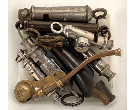 A small collection of whistles including boy scout with compass, girl guide etc 