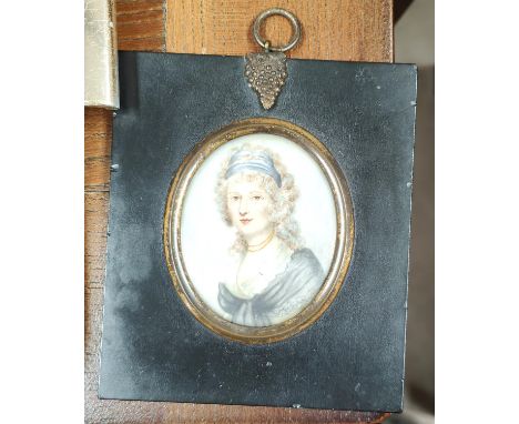 A 19th century miniature portrait of a woman in dress with scarf, in ebonised frame with gilt mount and grape hanger, ht 7cm 