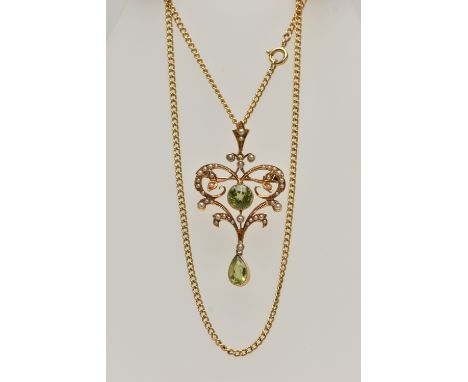 A YELLOW METAL GEM SET LAVALIER PENDANT/BROOCH WITH CHAIN, open work scroll pendant, set with a central circular cut peridot 