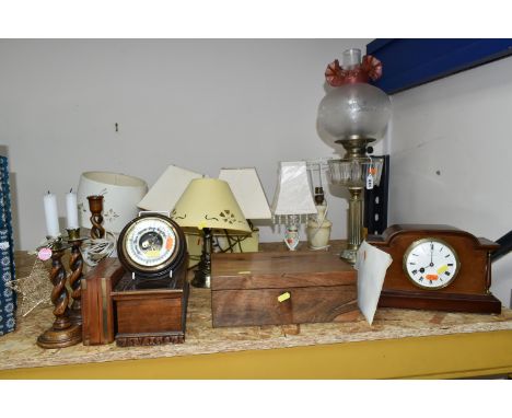 A GROUP OF BEDSIDE LAMPS, WOODEN BOXES AND A MANTEL CLOCK, comprising a Victorian oil lamp with a brass column on a black mar