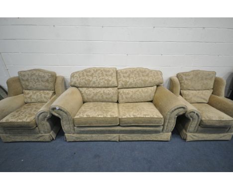 A FLORAL GOLD UPHOLSTERED THREE PIECE SUITE, comprising a two seater sofa, and two armchairs (condition:- some marks to armre