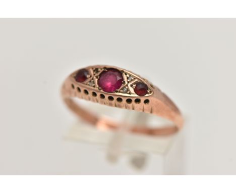 AN EARLY 20TH CENTURY, 9CT ROSE GOLD RUBY AND DIAMOND BOAT RING, set with three circular cut rubies interspaced with four sma