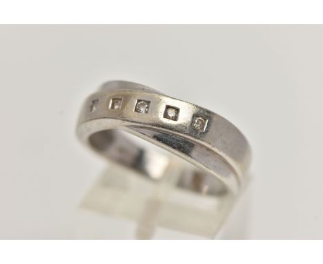 A 9CT WHITE GOLD DIAMOND RING, crossed band design set with a row of five small round brilliant cut diamonds, estimated total