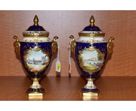 TWO COALPORT TWIN HANDLED VASES AND COVERS, blue, gilt and pale yellow ground, one a limited edition and hand painted with a 