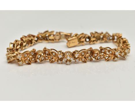AN 18CT GOLD DIAMOND SET BRACELET, articulated floral bracelet set with round brilliant cut diamonds, to an integrated push p