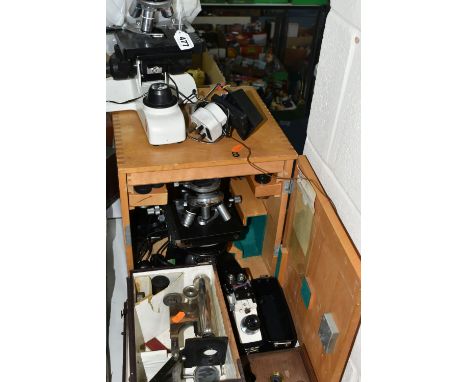 FOUR VINTAGE MICROSCOPES, comprising a PZO Warszawa research microscope model MB 8 in a wooden case, a small Swift  FM-31WD  