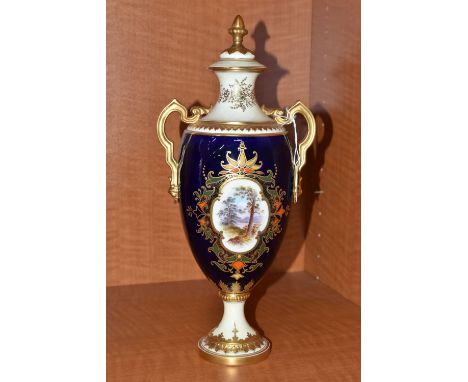 AN EARLY 20TH CENTURY COALPORT TWIN HANDLED PEDESTAL BALUSTER VASE AND COVER, blue, pale yellow and gilt ground and hand pain