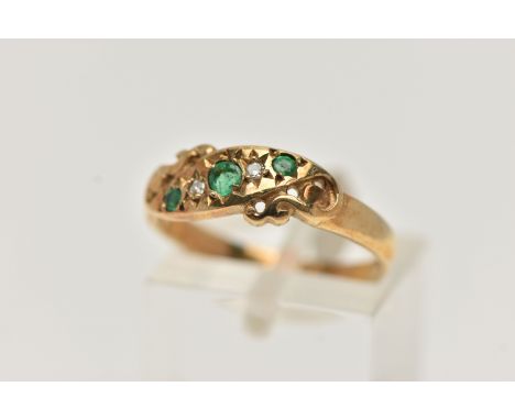 A 9CT GOLD EMERALD AND DIAMOND RING, set with three circular cut emeralds, interspaced with two star set single cut diamonds,