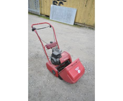 A SUFFOLK PUNCH CYLINDER PETROL 14S lawnmower, with grass box (engine turns)