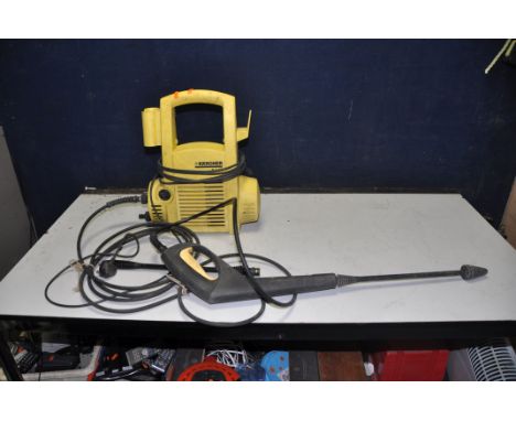 A KARCHER K2.86 JETWASH with lance and spare attachment (PAT pass and working but 'o' ring missing on pipework)