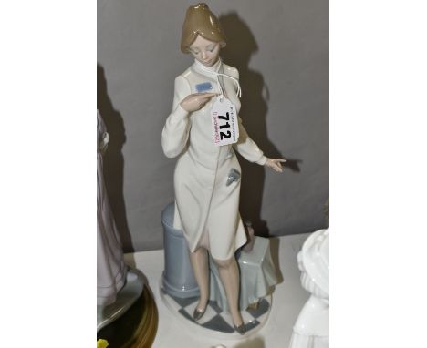 TWO LLADRO FIGURES, comprising Female Physician no 5197, designed by Salvador Debon 1984, retired 2005, height 33.5cm, and Gi