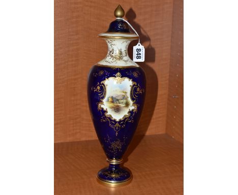 AN EARLY 20TH CENTURY COALPORT BALUSTER VASE AND COVER, blue, pale yellow and gilt ground and hand painted with a titled vign
