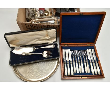 A BOX OF ASSORTED WHITE METAL WARE, to include a circular tray, a canteen of tea knives and forks each fitted with a carved m