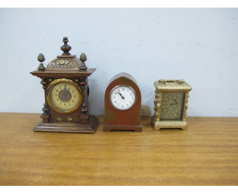 An Early XX Century Brass Arched Cased Bedside Clock, 9.5cm high, walnut cased mantle clock and a Trade Mark metal cased smal