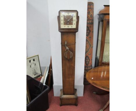 A 1930's Oak Grandmother Clock, with a square dial, Arabic numbers, trunk with applied decoration stepped base, on shaped fee