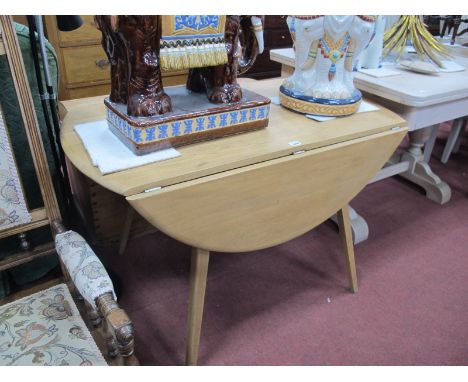 An Ercol Ash Drop Leaf Dining Table, 125cm wide x 70cm high.