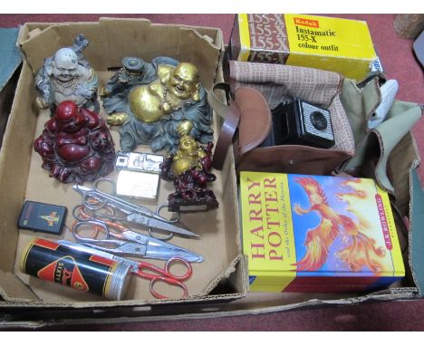 Resin Buddha Figures, scissors, lighters, Dunlop Sixty Five golf balls, cameras, Harry Potter book:- One Box.