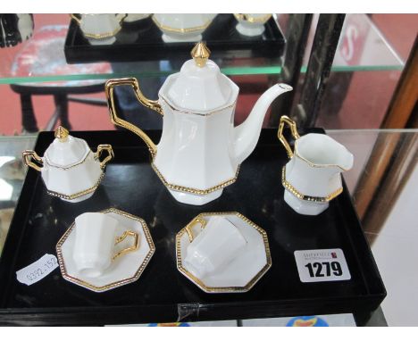 A Novelty Miniature Coffee Set, of octagonal design, comprising coffee pot, twin handled lidded sugar bowl, jug and two cups 