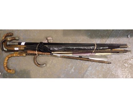 Three vintage umbrellas and a white metal topped cane. Not available for in-house P&amp;P 