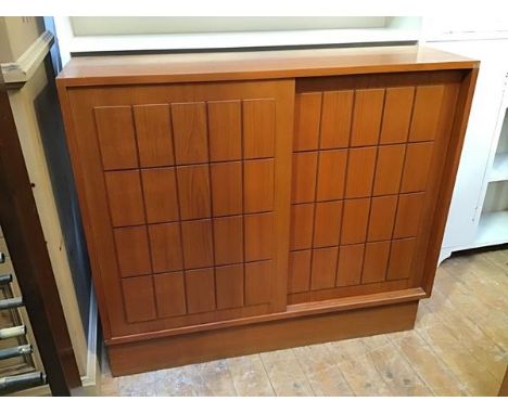 A mid century bookcase fitted two panel sliding doors and shelved interior (lacking superstructure, some losses to veneer) on