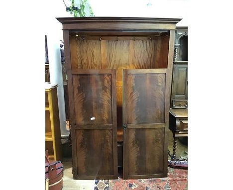 An Edwardian mahogany bow front two door wardrobe with boxwood inlay, the interior fitted hanging rail, with single frieze dr