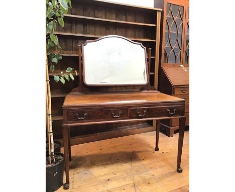 A mahogany Whytock &amp; Reid  dressing table with hinged mirror, the top with moulded edge above a single slide (lacking pol