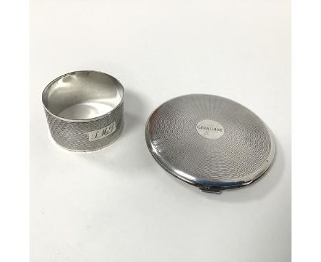 A silver napkin ring with engine turned decoration (2.5cm x 4.5cm) (22.31g) and an engine turned compact, engraved Geraldine 