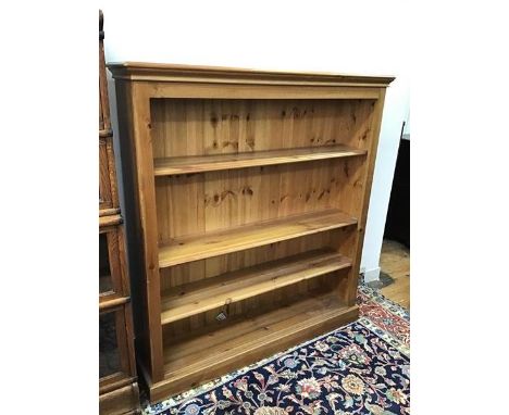 A modern pine open bookcase, fitted three adjustable shelves on plinth base (138cm x 126cm x 29cm)