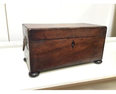 A 19thc mahogany tea caddy with shell inlay to top above a fitted interior (lacking bowl), with lion mask handles to side (on