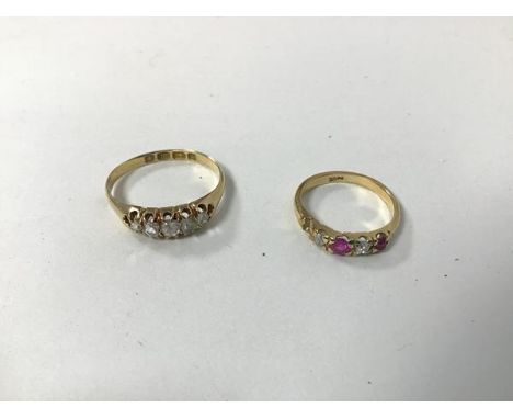 An 18ct gold ring set five graduated diamonds within a pierced setting (O) and another gold ring set central ruby flanked by 