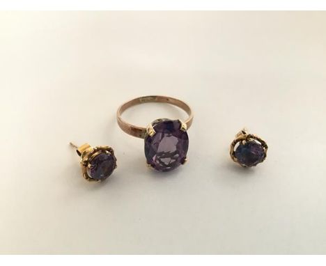 A single stone amethyst ring, high claw set on a yellow metal band (unmarked) together with a pair of amethyst stud earrings,