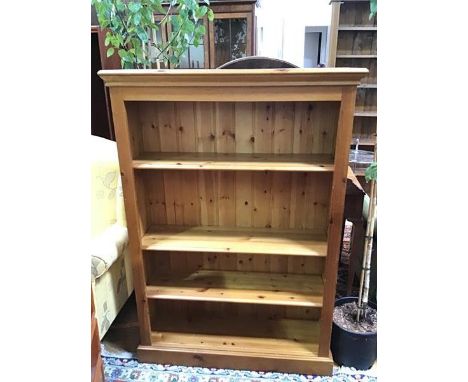 A modern pine open bookcase fitted three adjustable shelves, on plinth base (137cm x 96cm x 29cm)