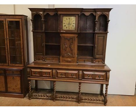 An oak late Victorian dresser in early 18thc style, with a central clock marked Torkington, Newcastle, surrounded by an arran