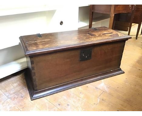 An 18thc mahogany kist with oak top and later hinges, lacking lock mechanism, top with moulded edge, on moulded plinth base (