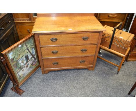 An early 20th century oak chest of three drawers, brass drop handles c.1930; an oak sewing compendium on stand, castors; an o