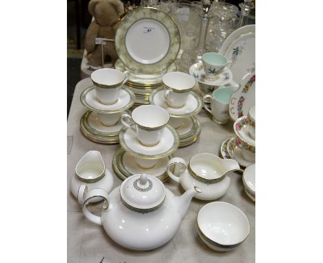 A Royal Doulton Isabella pattern dinner service, comprising seven dinner plates, four dessert plates, eight side plates, sauc