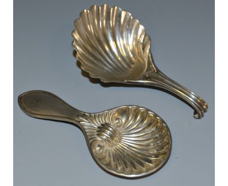 An early 19th century silver caddy spoon, as a scallop shell,  Birmingham 1835; another similar caddy spoon (2)