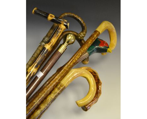 Walking sticks - including a banded walking stick, white metal mount, curved handle culminating in an acorn; a twisted hedger