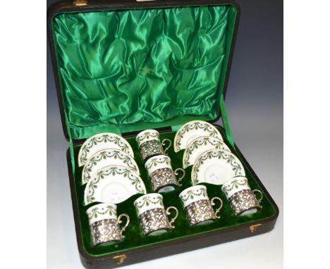 Boxed set of six Crescent China coffee cans with saucers and silver holders, the case marked Walker and Hall, Sheffield; 