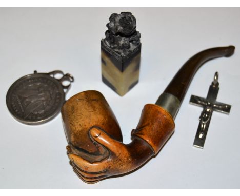 A silver crucifix, Birmingham hall mark; a carved soapstone Chinese seal; a silver dollar, 1884; a Meerschaum pipe as a hand 