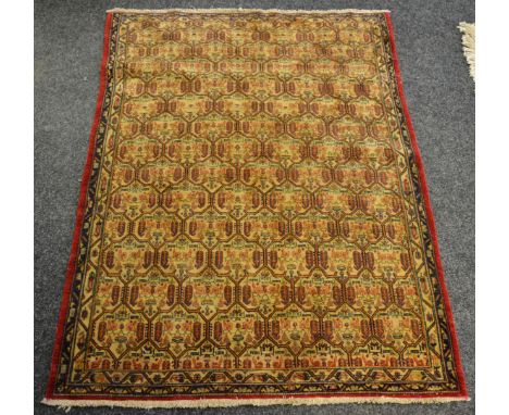 A Tafresh carpet, the madder field decorated with floral motifs in tones of red on a cream ground, conforming borders, 228cm 