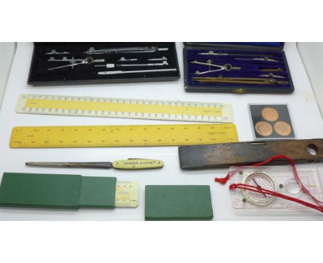 Two technical drawing sets, an Ullathorne &amp; Co. metamorphic ruler, a treen ring sizer, spirit level, rulers, etc.