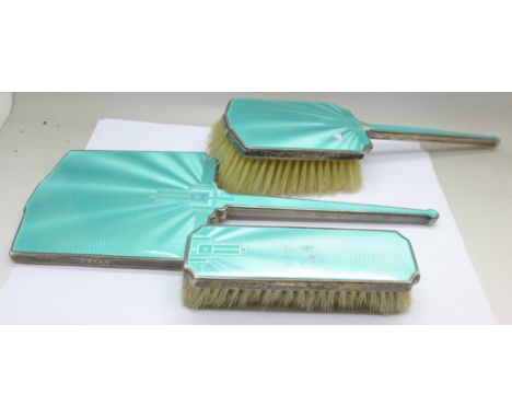 A silver and enamel mirror and two brushes, a/f